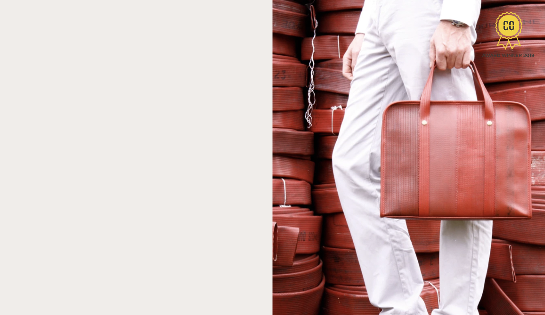 Person holding Elvis & Kresse upcycled bag in front of a stack of hose pipes