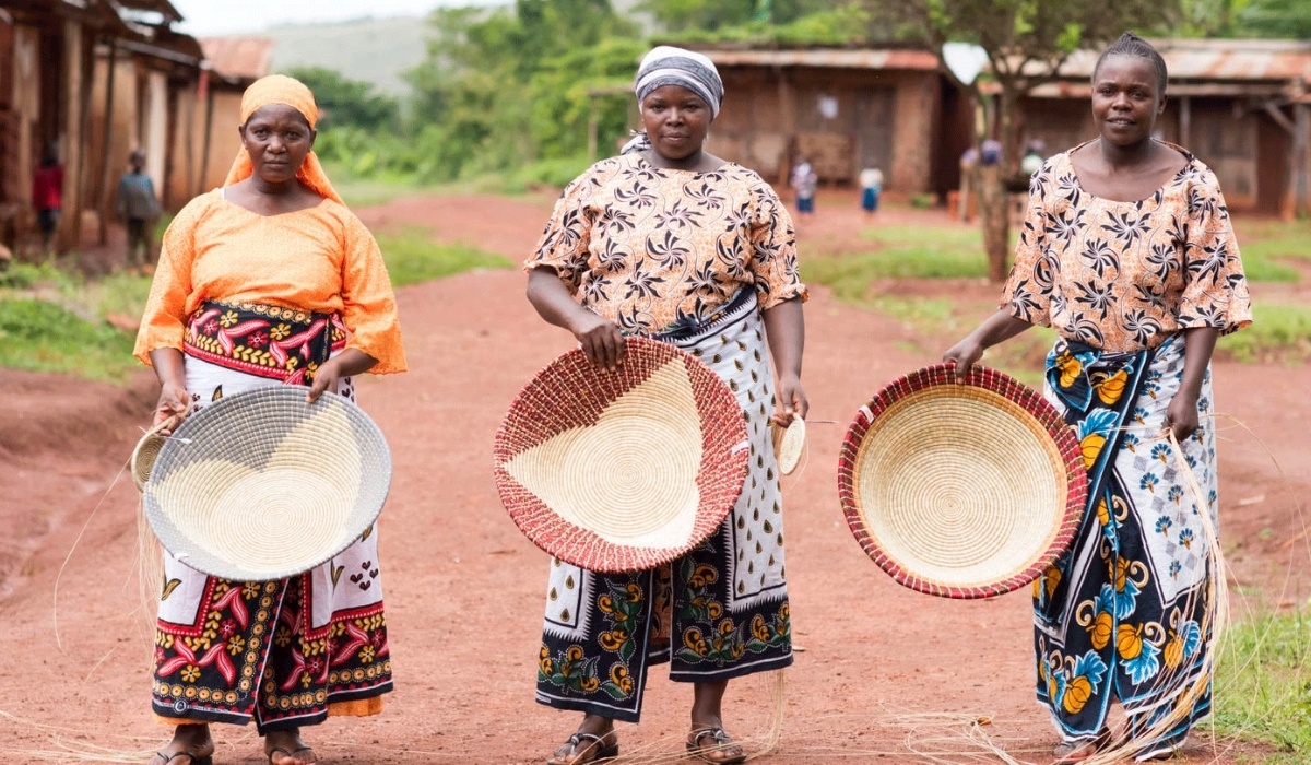 Three women artisans holding their handmade products