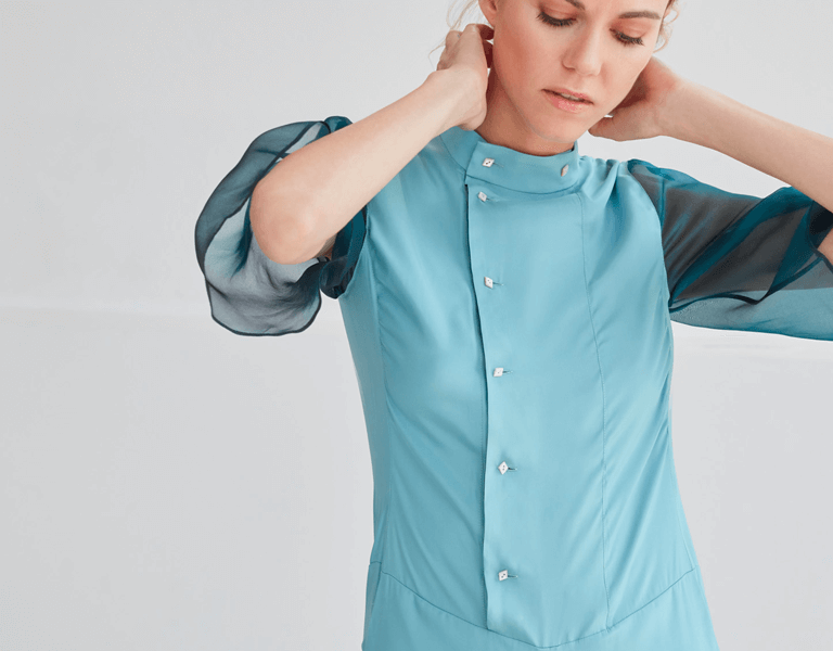 Model wearing blue sustainable sheer officewear top
